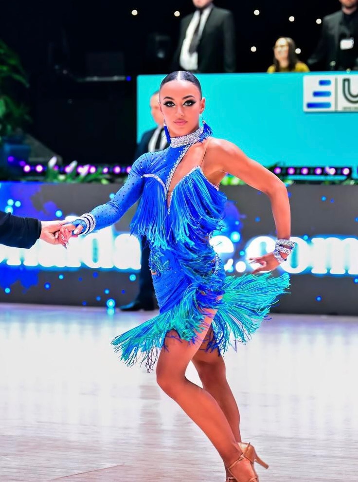 Christina Katsaros competing in blue